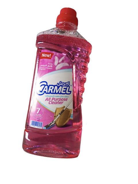 Pink bottle of Carmel all-purpose cleaner on a counter with a blurred background