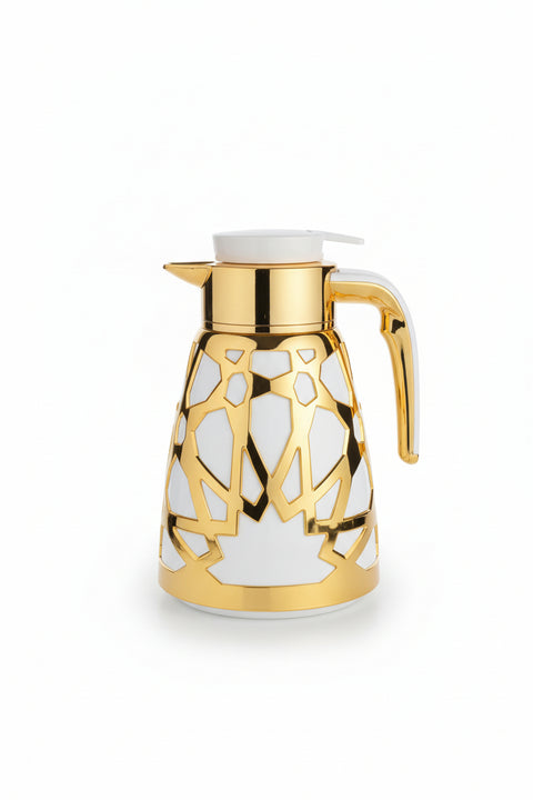 Decorative glass pitcher with gold accents on a plastic surface