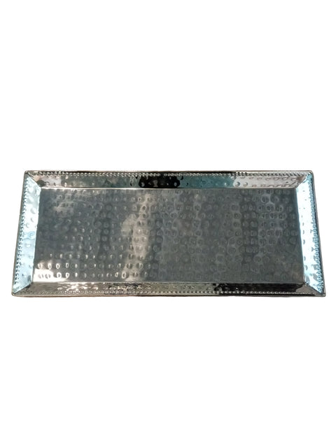 Metallic rectangular tray on a wooden surface