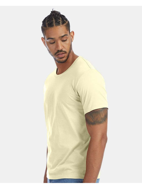Man wearing a light yellow t-shirt on a white background