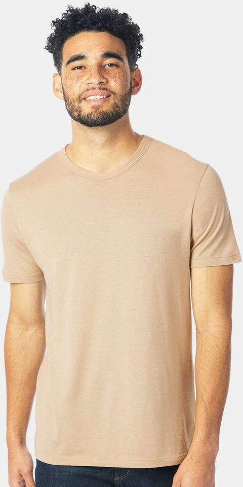 Man wearing a beige t-shirt against a white background