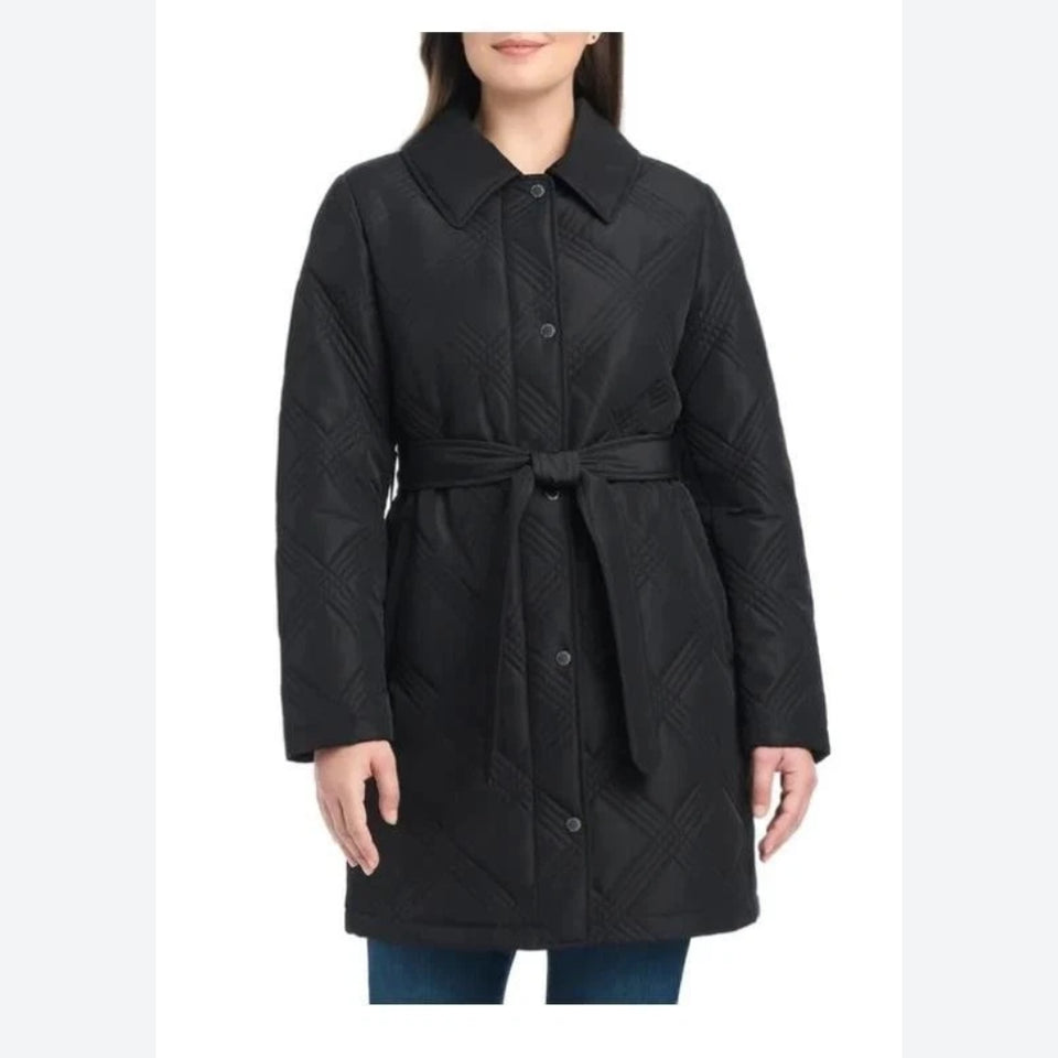 A woman wearing a black quilted coat with a collar, front buttons, and a matching waist tie, shown against a plain white studio background.