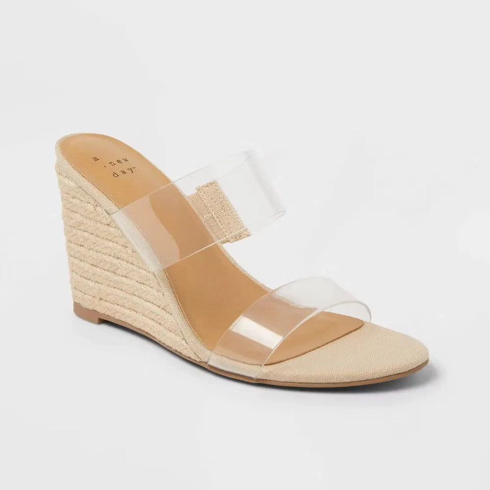Beige wedge sandal with clear straps on a light gray background