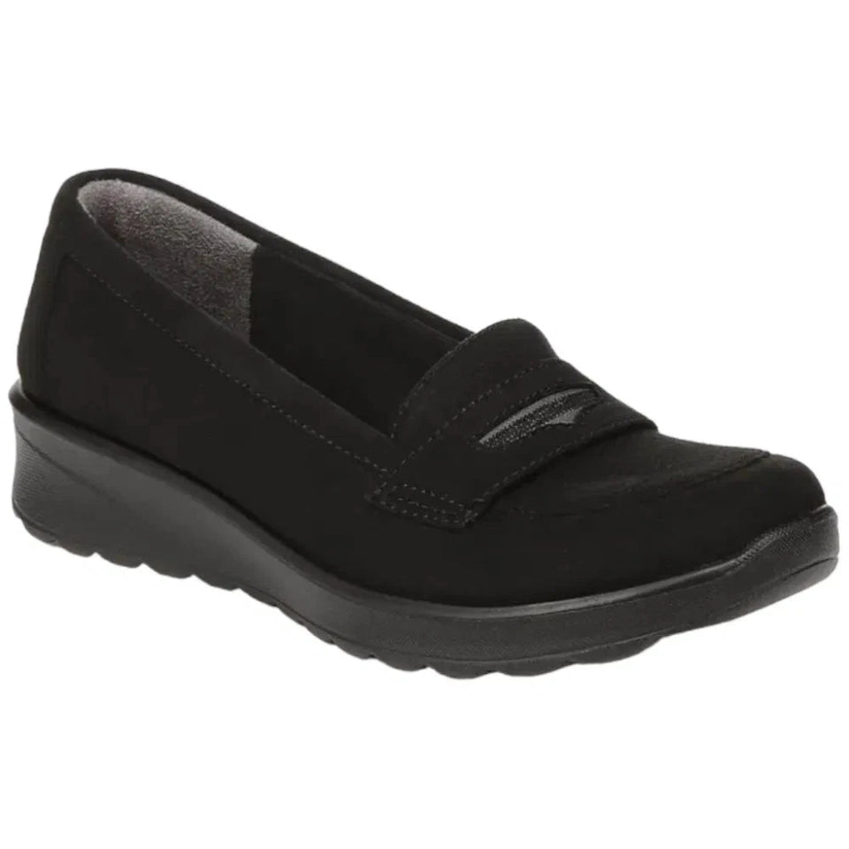 A single black slip-on wedge shoe with a textured sole and a small metallic logo on the strap, shown against a plain white background.