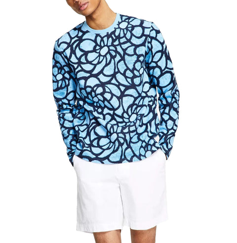 Person wearing a blue patterned long-sleeve shirt and white shorts on a white background