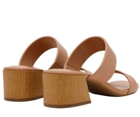 Pair of tan sandals with wooden soles on a white background