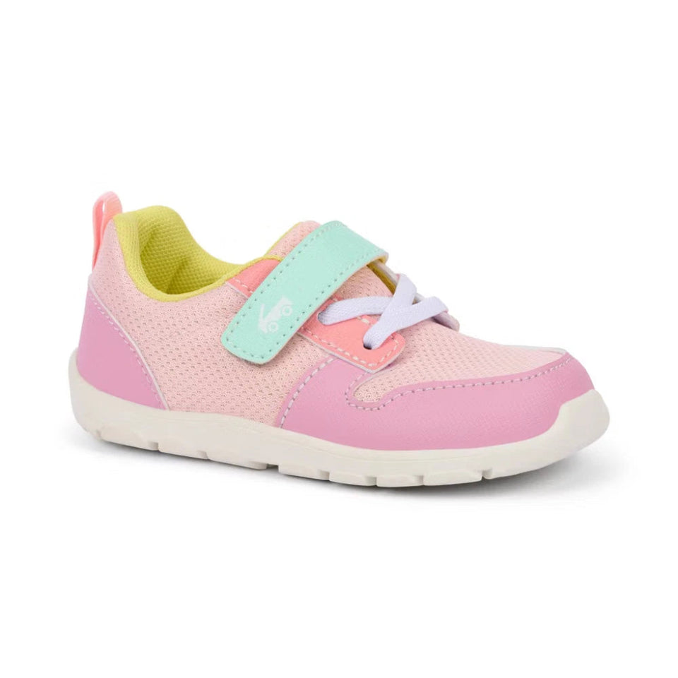 Pink children's sneaker with a green strap on a white background