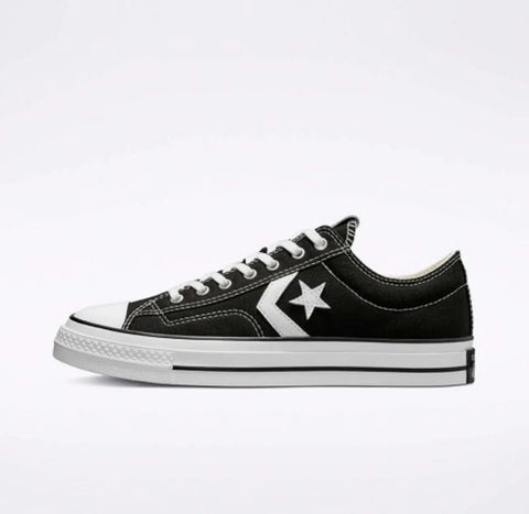 Black and white sneaker with a star logo on a light gray background