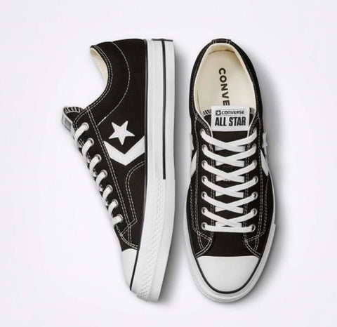 Black Converse All Star sneakers with white laces and star logo on a white background