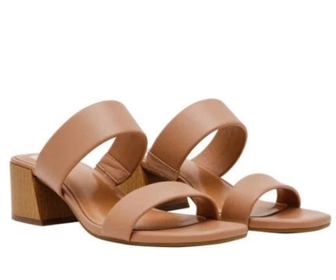 Pair of tan sandals with wooden block heel on a white background