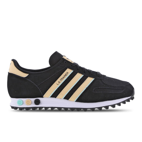 Black sneaker with beige stripes on a white background