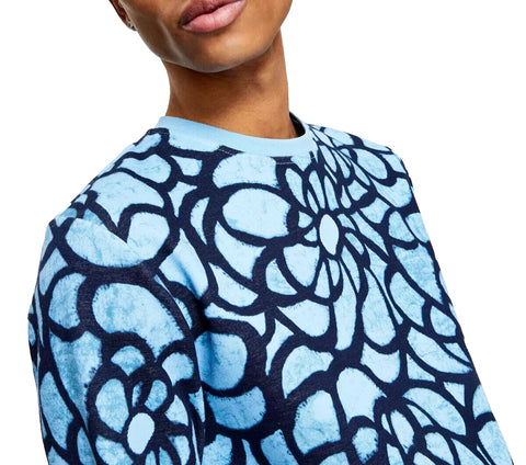 Person wearing a blue and black patterned top on a white background