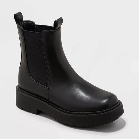 Black Chelsea boot on a light gray background