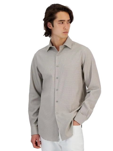 Man wearing a light gray dress shirt on a white background
