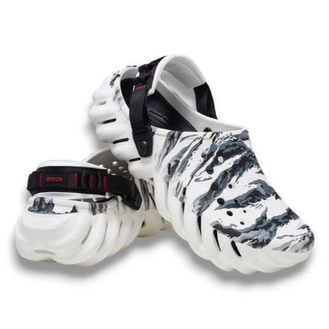 White clogs with black abstract pattern on a white background