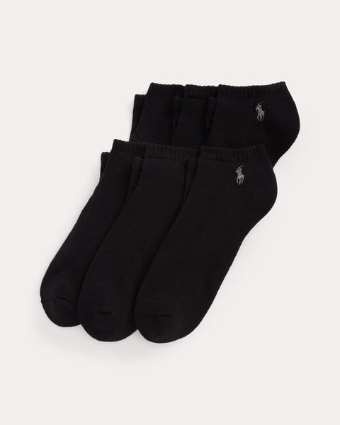 Three pairs of black socks with a logo on a light gray background