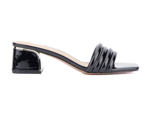 Black patent leather sandal with a block heel on a white background