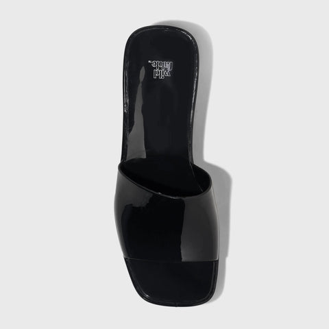 Black high-heeled shoe on a light gray background
