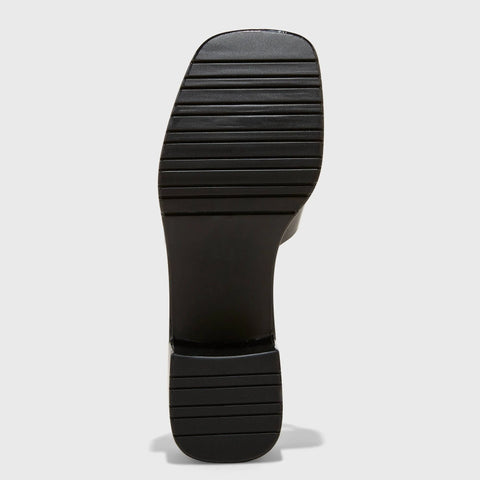 Close-up of a black shoe sole on a light gray background