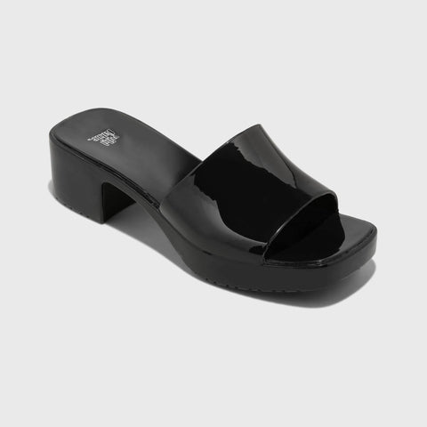 Black patent leather sandal on a light gray background