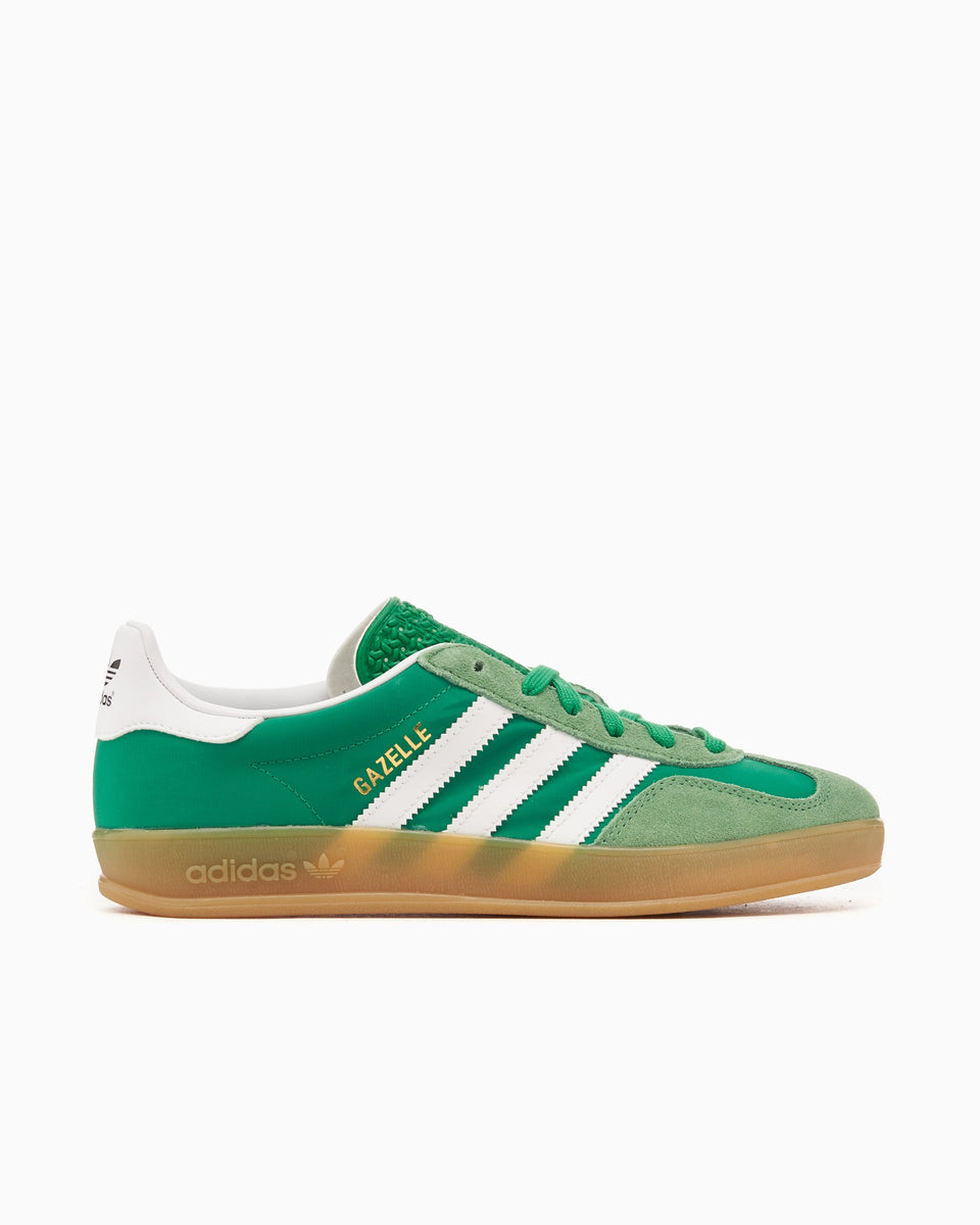 Green Adidas sneaker with white stripes on a white background