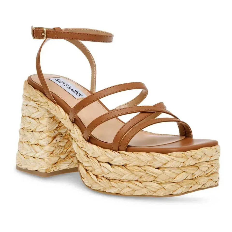 Brown sandal with woven platform on a white background