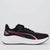A black Puma running shoe with a thick white midsole and vibrant pink accents, shown in a side profile on a light gray background.