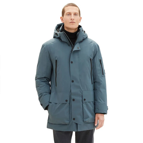 Man wearing a blue coat on a white background