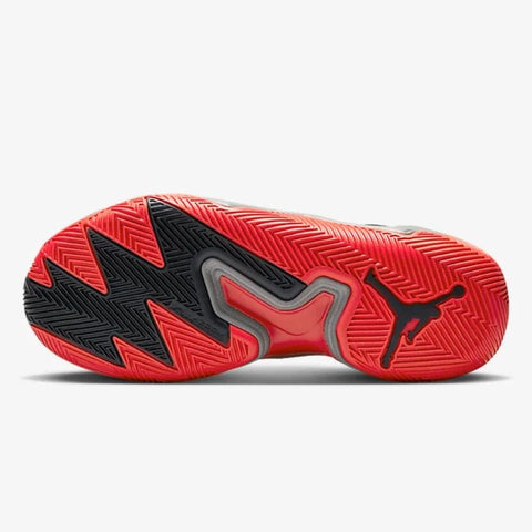 Red and black sneaker with a prominent brand logo on a white background