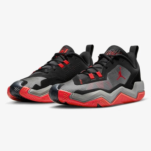 Black, gray, and red sneakers with a prominent brand logo on a white background