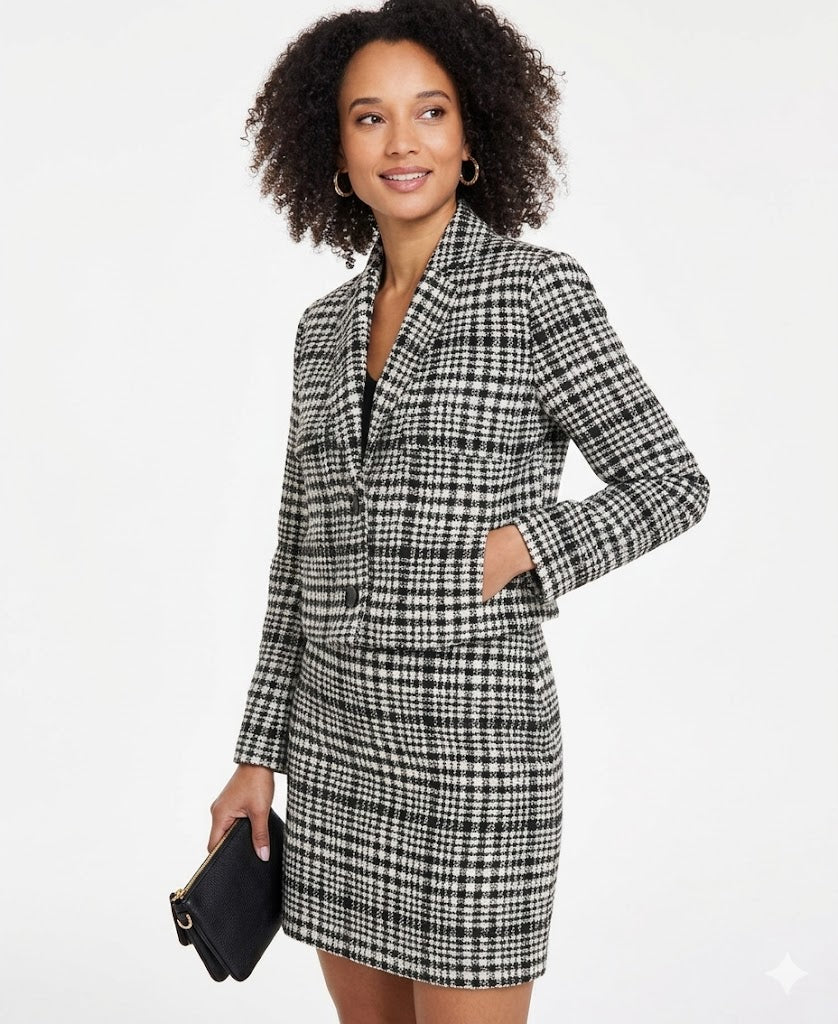 Woman wearing a black and white checkered blazer dress on a white background