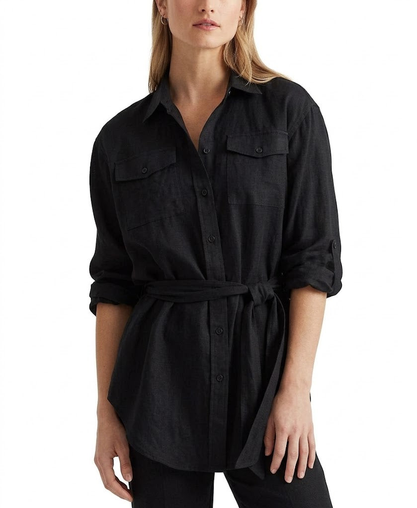 Woman wearing a black shirt with a belt on a white background