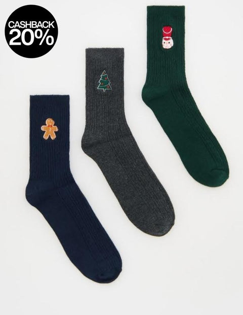 Three socks with festive designs on a white background
