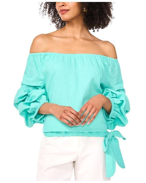 Woman wearing a turquoise off-shoulder top with ruffled sleeves on a white background