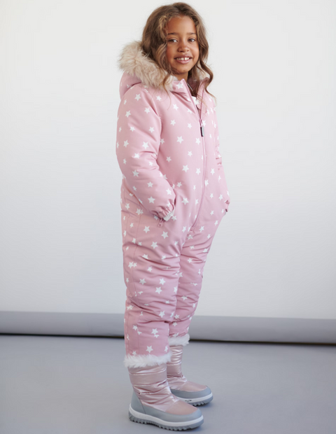 Child wearing a pink snowsuit with white star pattern on a plain background