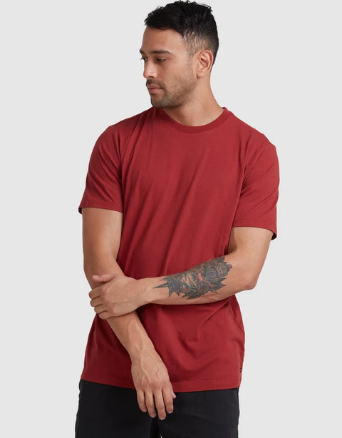Man wearing a red t-shirt against a plain background