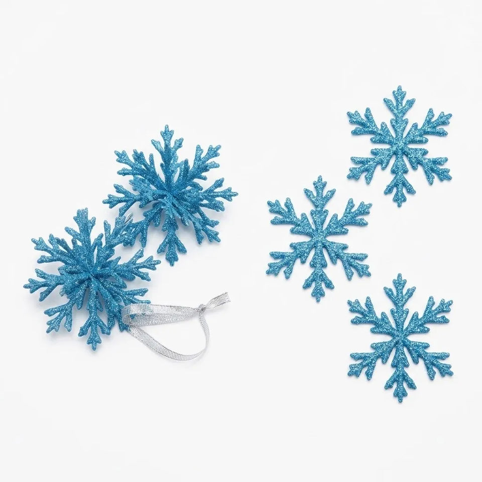 Five glittery blue snowflake ornaments with silver hanging ribbons, arranged on a plain white background.