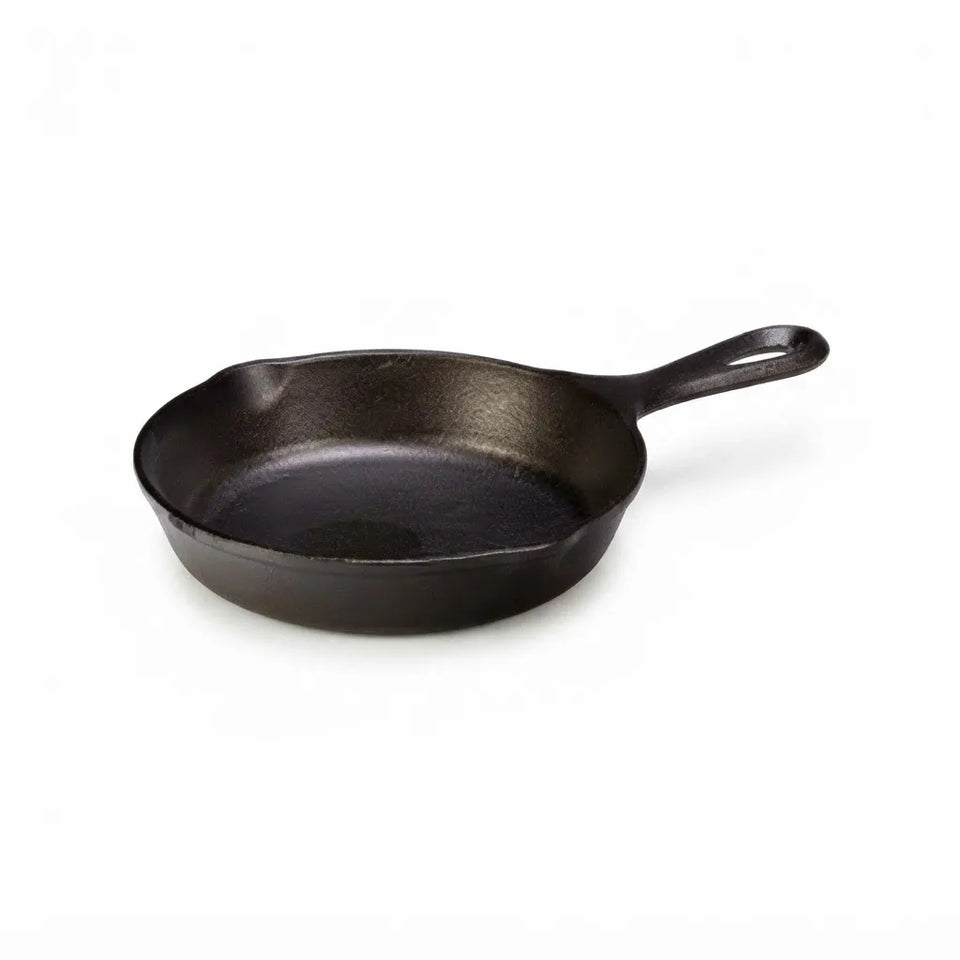 A classic black cast iron skillet with a long handle, photographed on a clean white background.