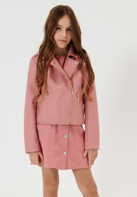 A girl wearing a pink biker jacket with a mandarin collar, zipper details, and a matching pink skirt.