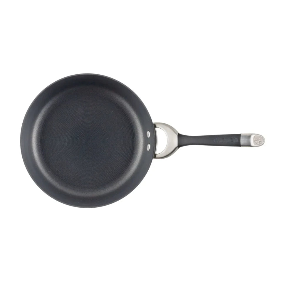 Black frying pan with a handle on a white background