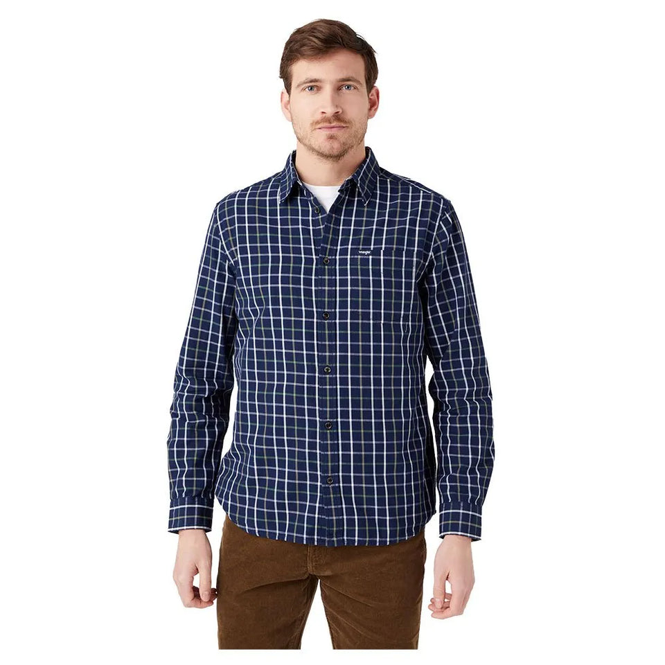 Man wearing a blue plaid shirt on a white background